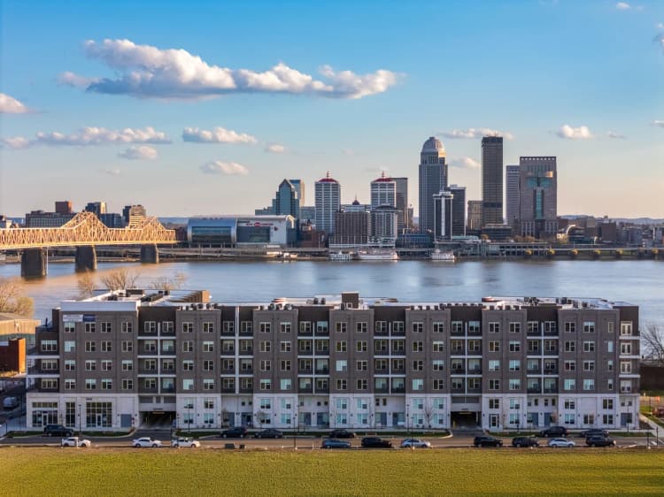 Louisville apartments for rent - image - Modern apartment building with waterfront and city skyline