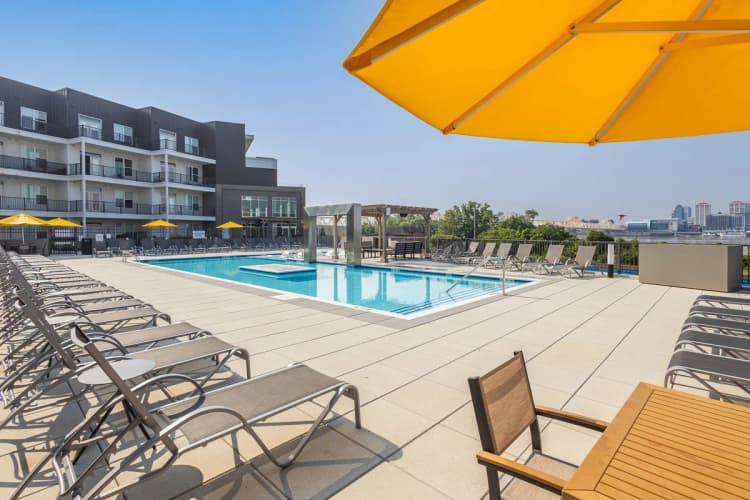 Louisville apartments for rent - image - Rooftop pool deck with lounge chairs and yellow umbrellas