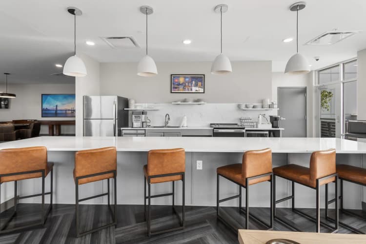 Louisville apartments for rent - image - Communal kitchen with bar seating and pendant lights