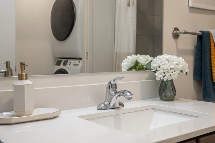 Louisville apartments for rent - image - Bathroom vanity with white flowers and towel bar