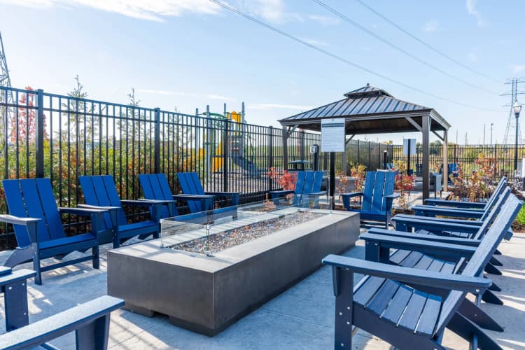 Louisville apartments for rent - image - A gazebo is surrounded by blue chairs and a fire pit.