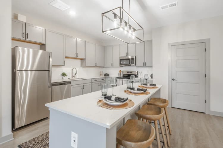 Louisville apartments for rent - image - A modern kitchen with a white countertop and stainless steel appliances.